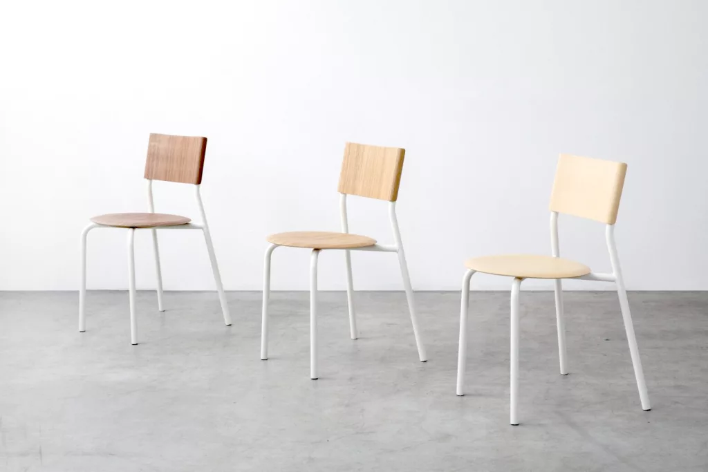 Three metal and wood chairs on a white background